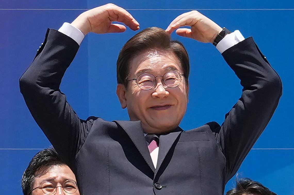李在明星期三（6月4日）上午宣誓就职，正式开启五年韩国总统任期。图为李在明在就职仪式后离开国会时，向民众比心。 （法新社）